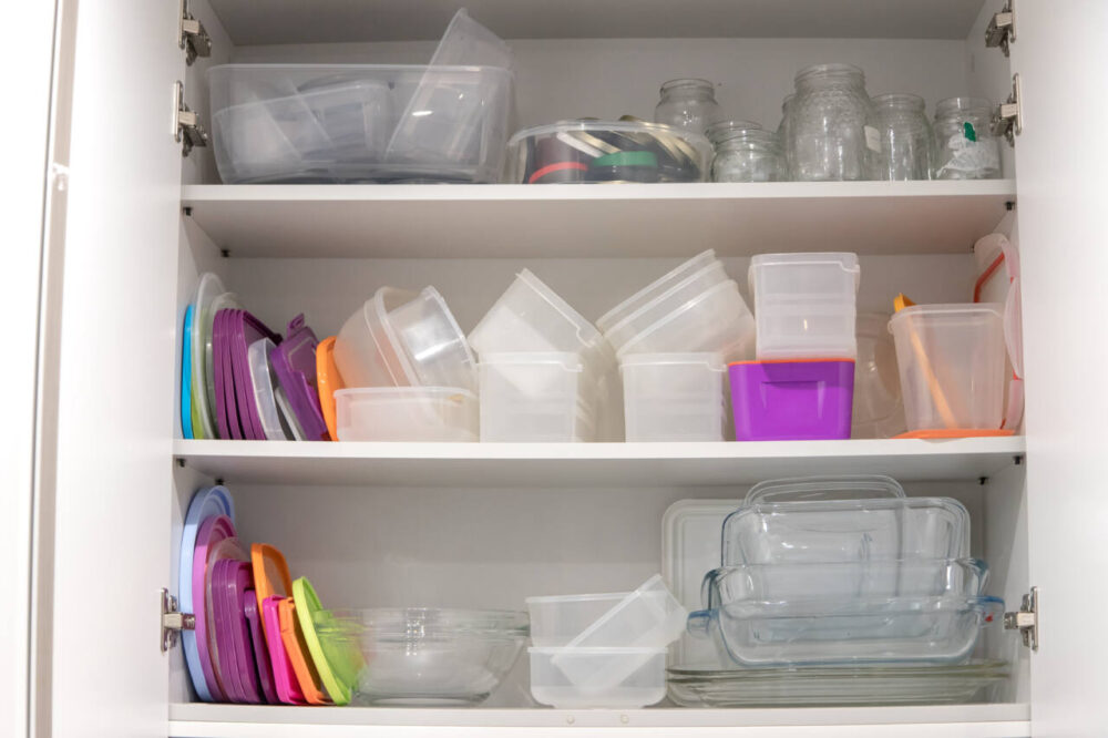plastic containers and lids in cabinet