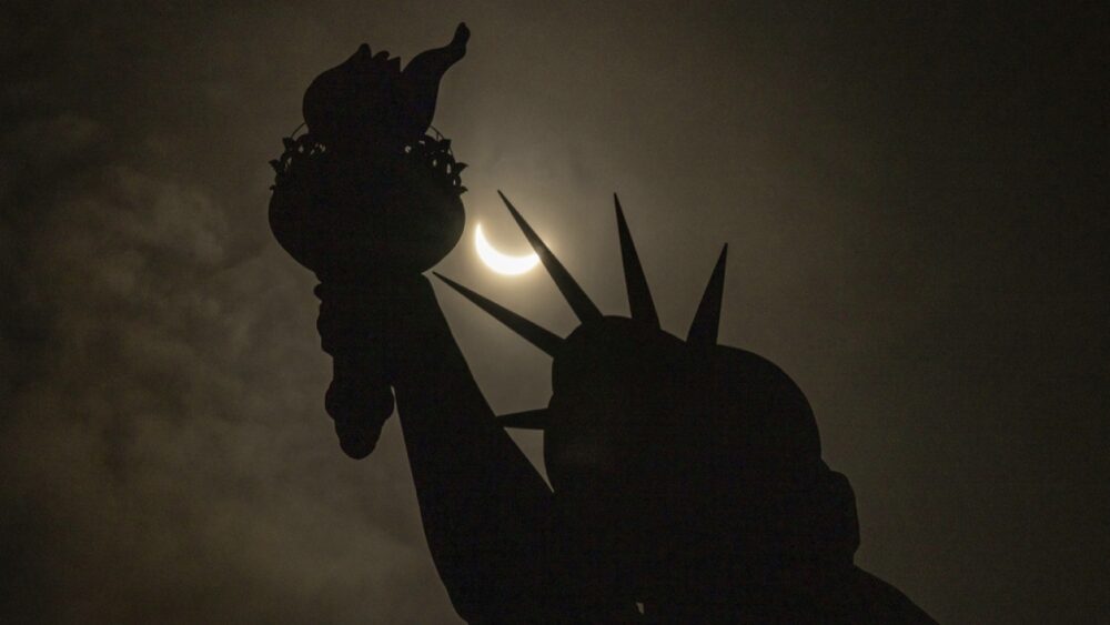 Eclipse over statue of liberty