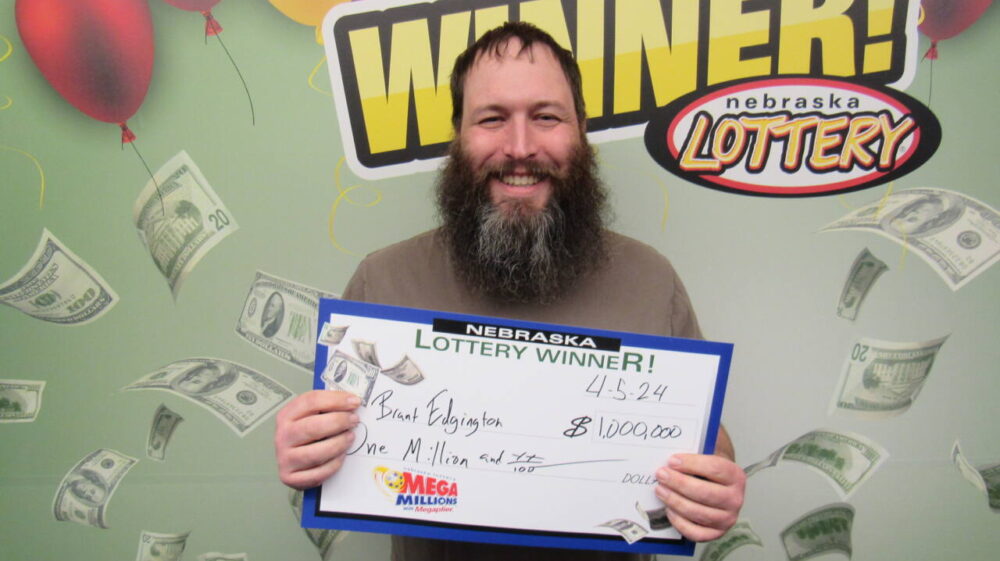 Brant Edgington holds $1 million Nebraska lottery check