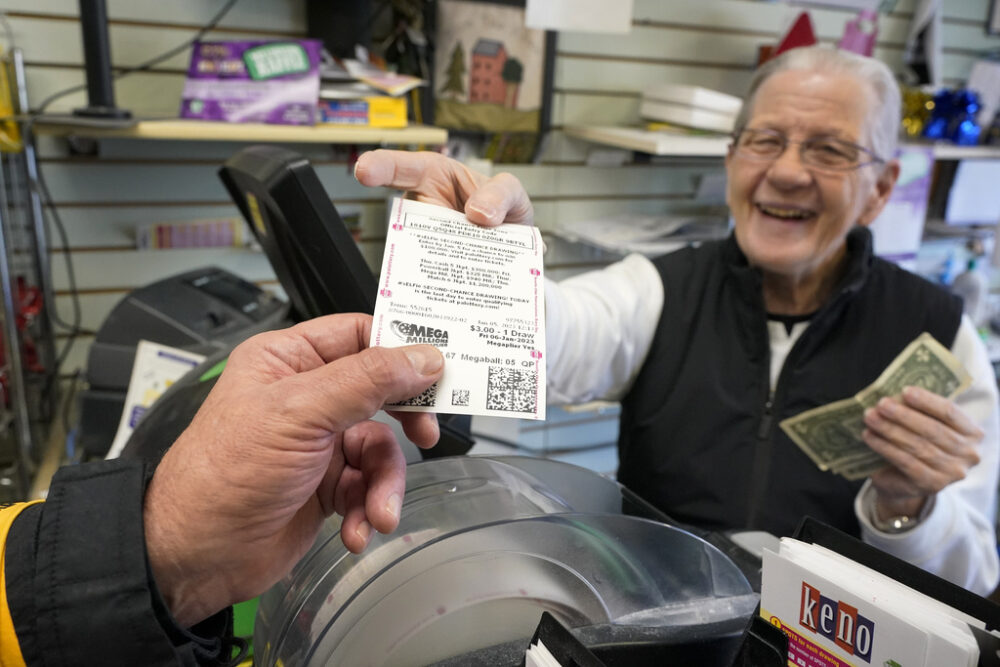 Shop owner hands a customer a lottery ticket