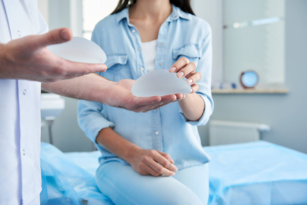 A doctor holds silicone breast implants