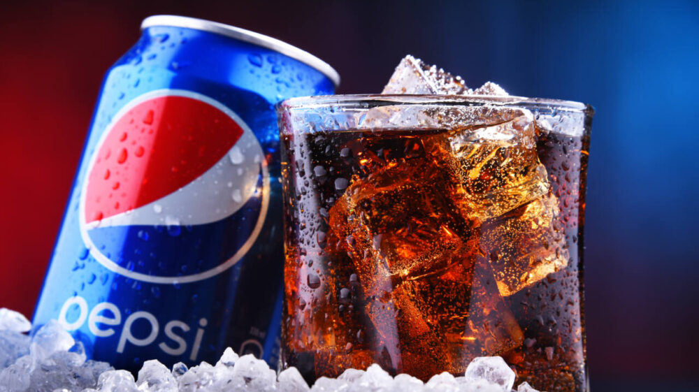 Pepsi can and soda in icy glass