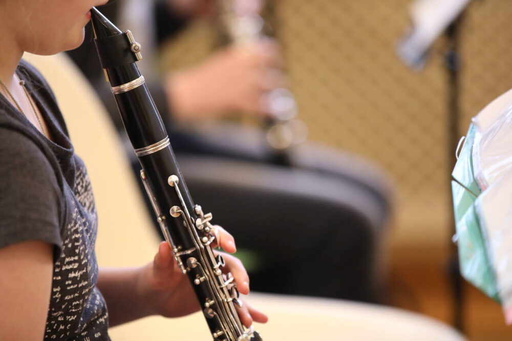 A young girl plays clarinet
