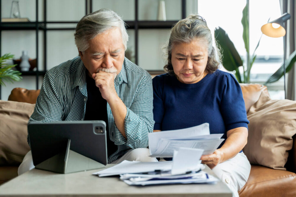 Retired couple looks at bills