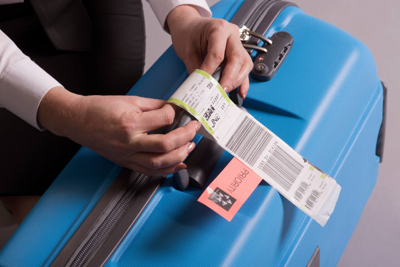 Airline tags on a blue suitcase