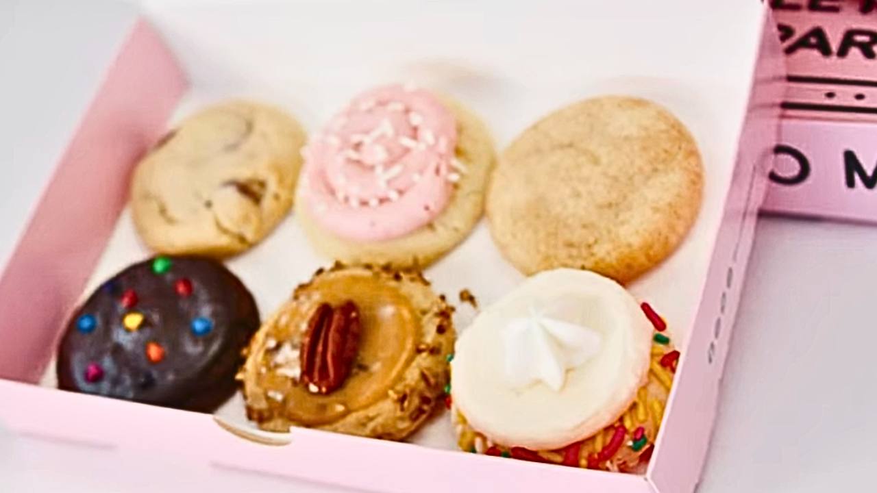 Six Crumbl mini cookies in pink box