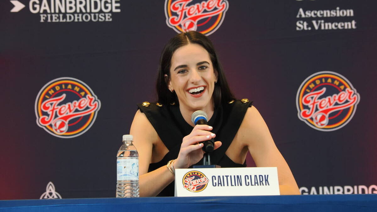 caitlin clark smiles at a WNBA press conference