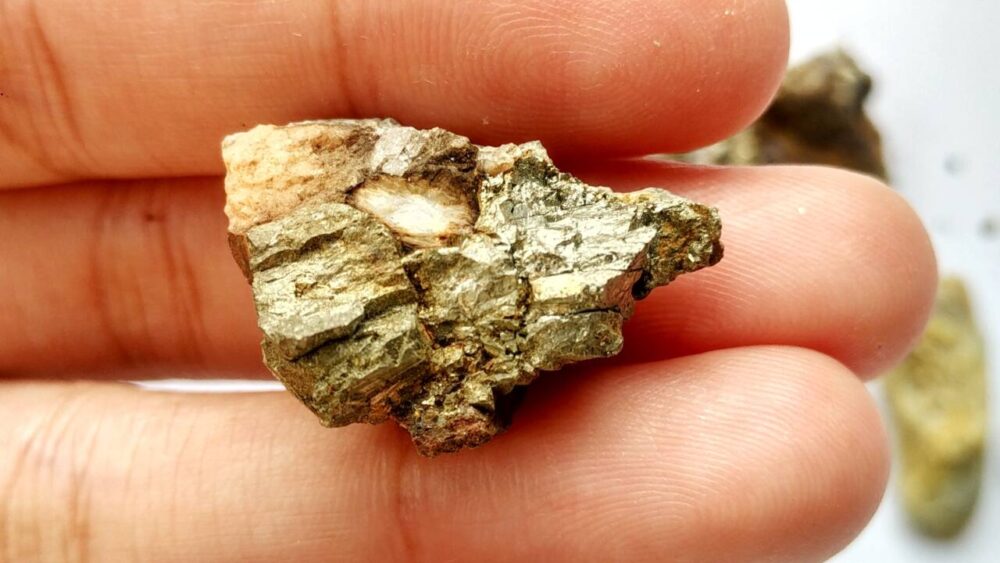 A pyrite rock in a person's hand