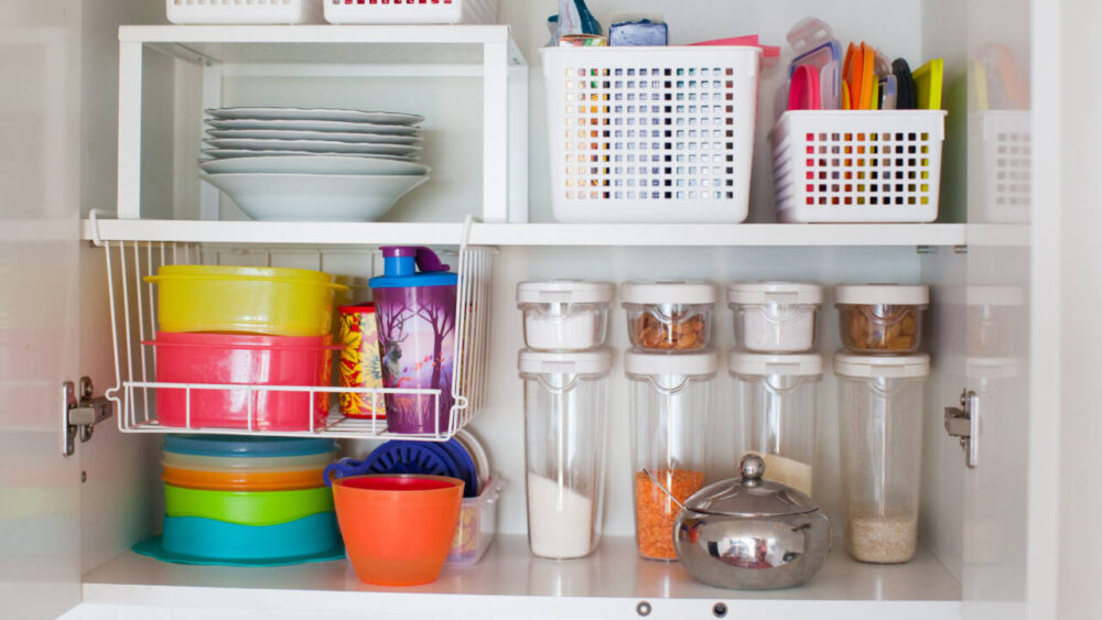 Food storage containers and their lids are stored in a cupboard.